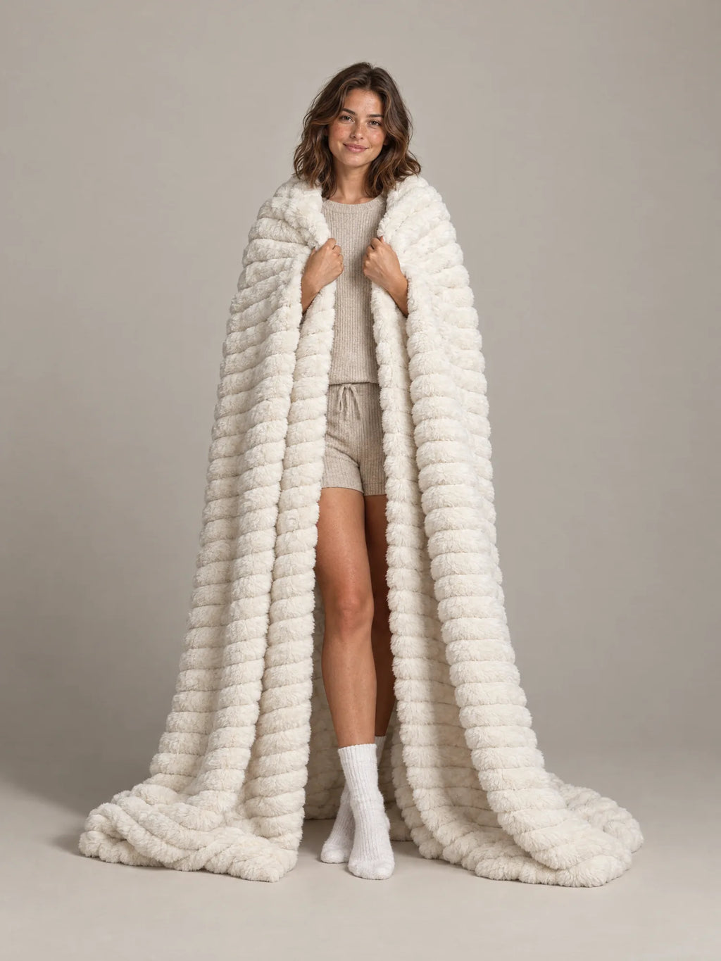 Woman wrapped in the Loona Stretch Plush Faux Fur Blanket