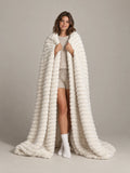 Woman wrapped in the Loona Stretch Plush Faux Fur Blanket