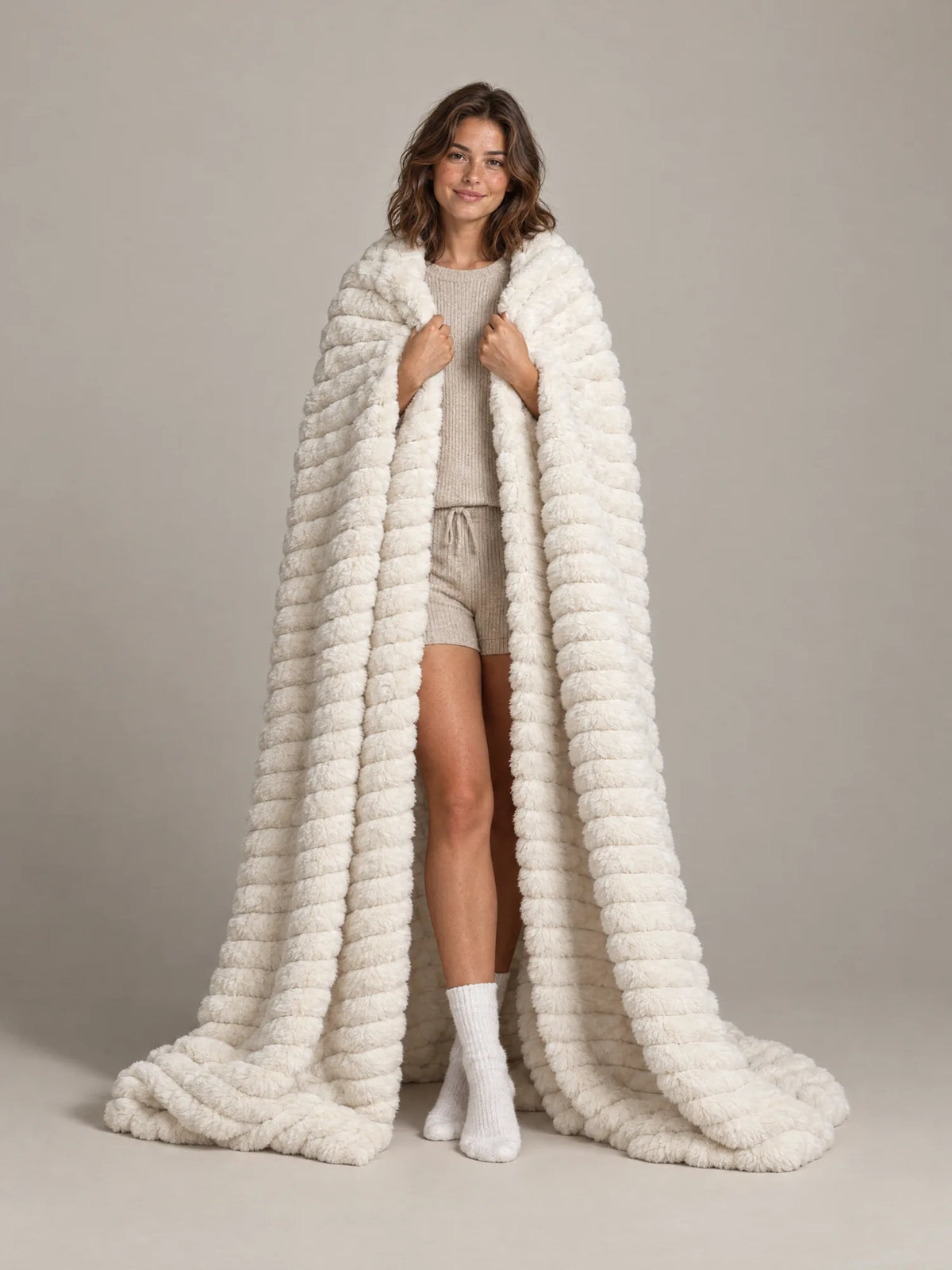 Woman wrapped in the Loona Stretch Plush Faux Fur Blanket