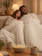 Couple under the Stretch Plush blanket on movie night